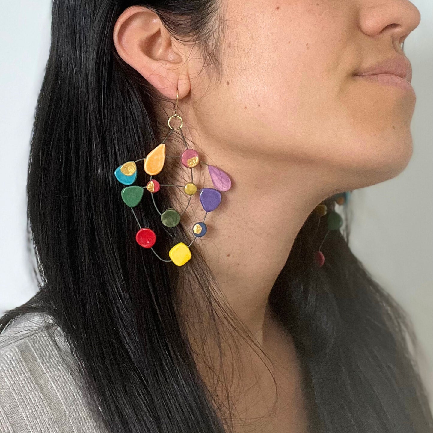 Close-up of Emy modelling My Voice of Colours earrings, featuring colourful ceramic pieces that reflect creativity and self-expression.
