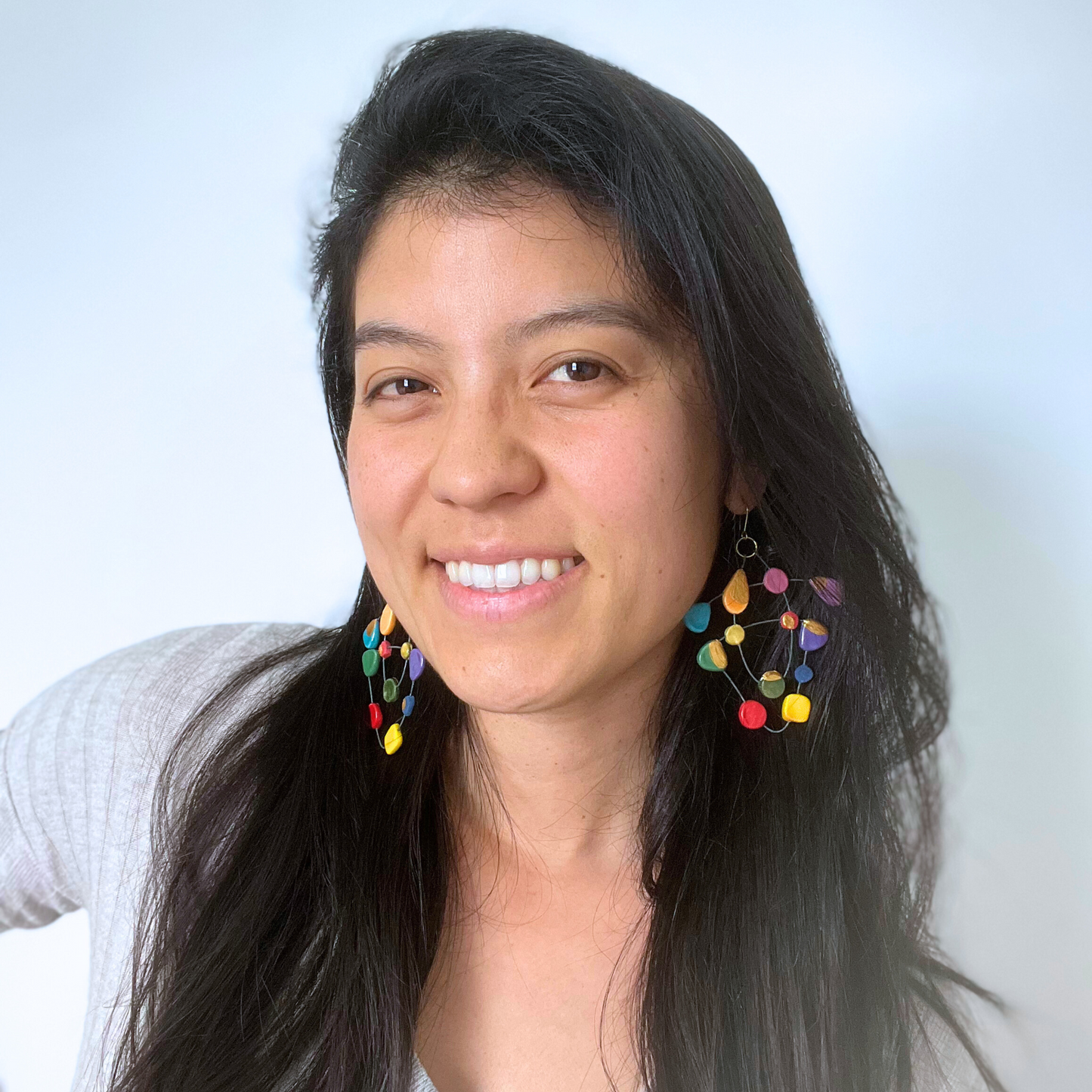 Emy wearing My Voice of Colours ceramic earrings, showcasing vibrant, handcrafted design that symbolises personal transformation and empowerment.