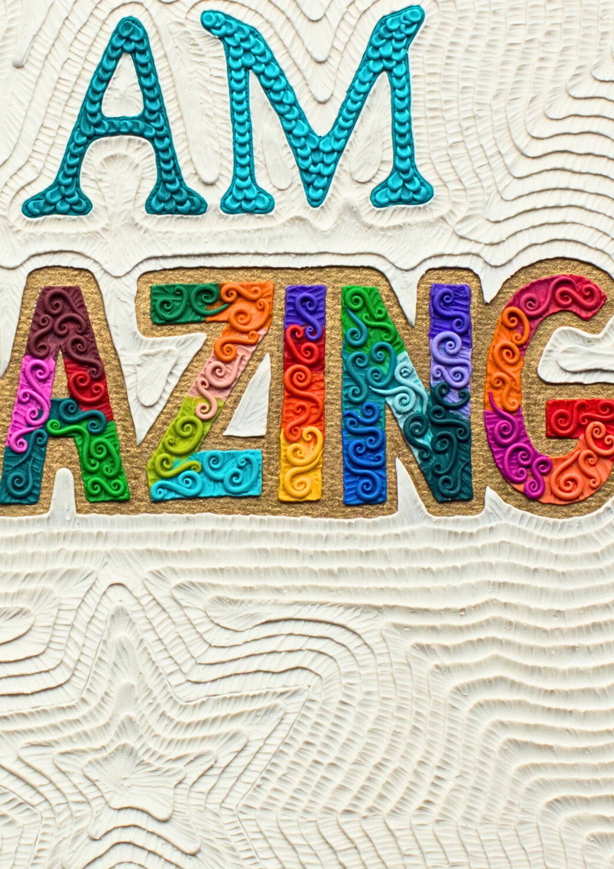 Close up of a Decorative wall art print that sais text 'I AM AMAZING' in colorful, raised letters on a textured off-white background. Plasticine clay art by New Zealand artist Emy Oikawa from Eclo Art.