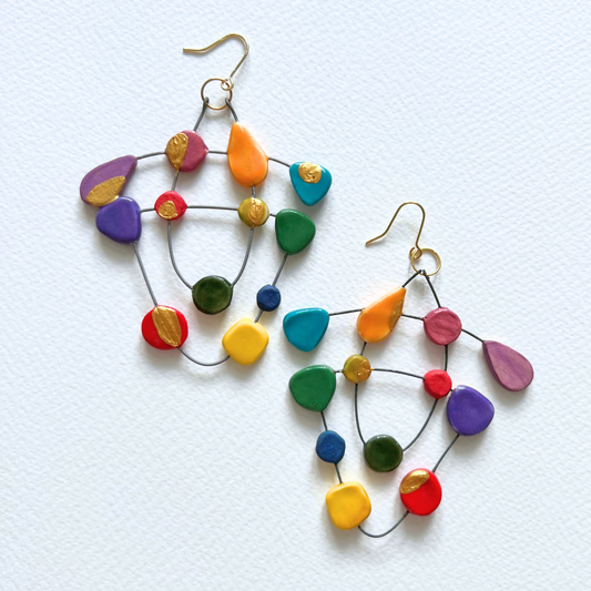 My Voice of Colours ceramic earrings displayed on a clean white background, highlighting their intricate design and bright, bold colors.