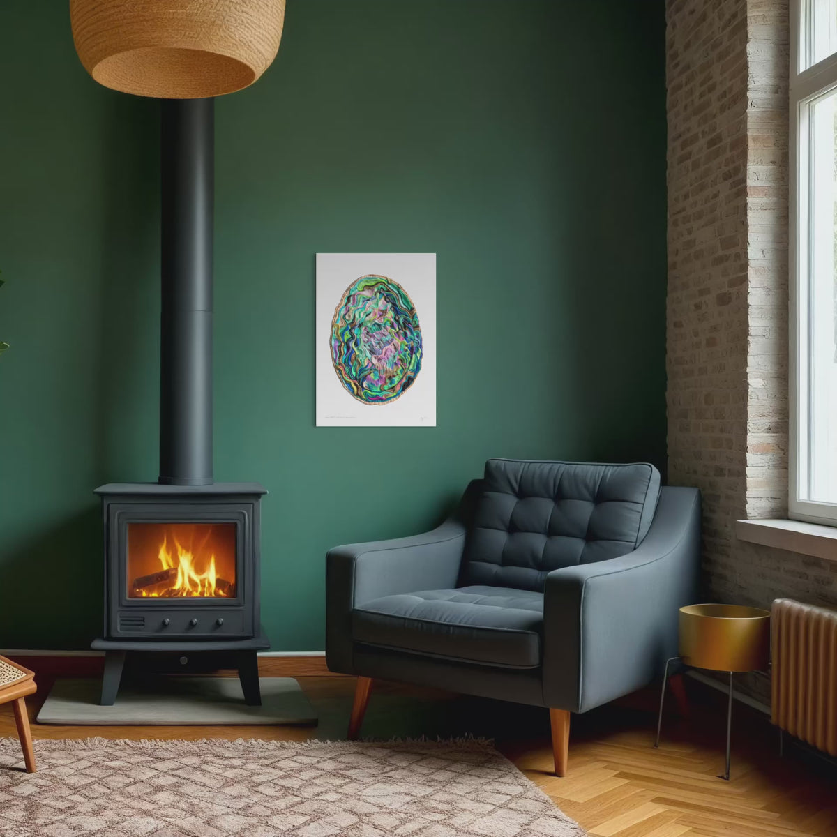 A close up video to a colorful Paua Shell A3 Art Print hangs on a dark green wall in a modern living room setting with a black wood stove, a gray armchair, and a brick column. Perfect to bring a New Zealand nature piece home. By Emy Oikawa from Eclo Art.