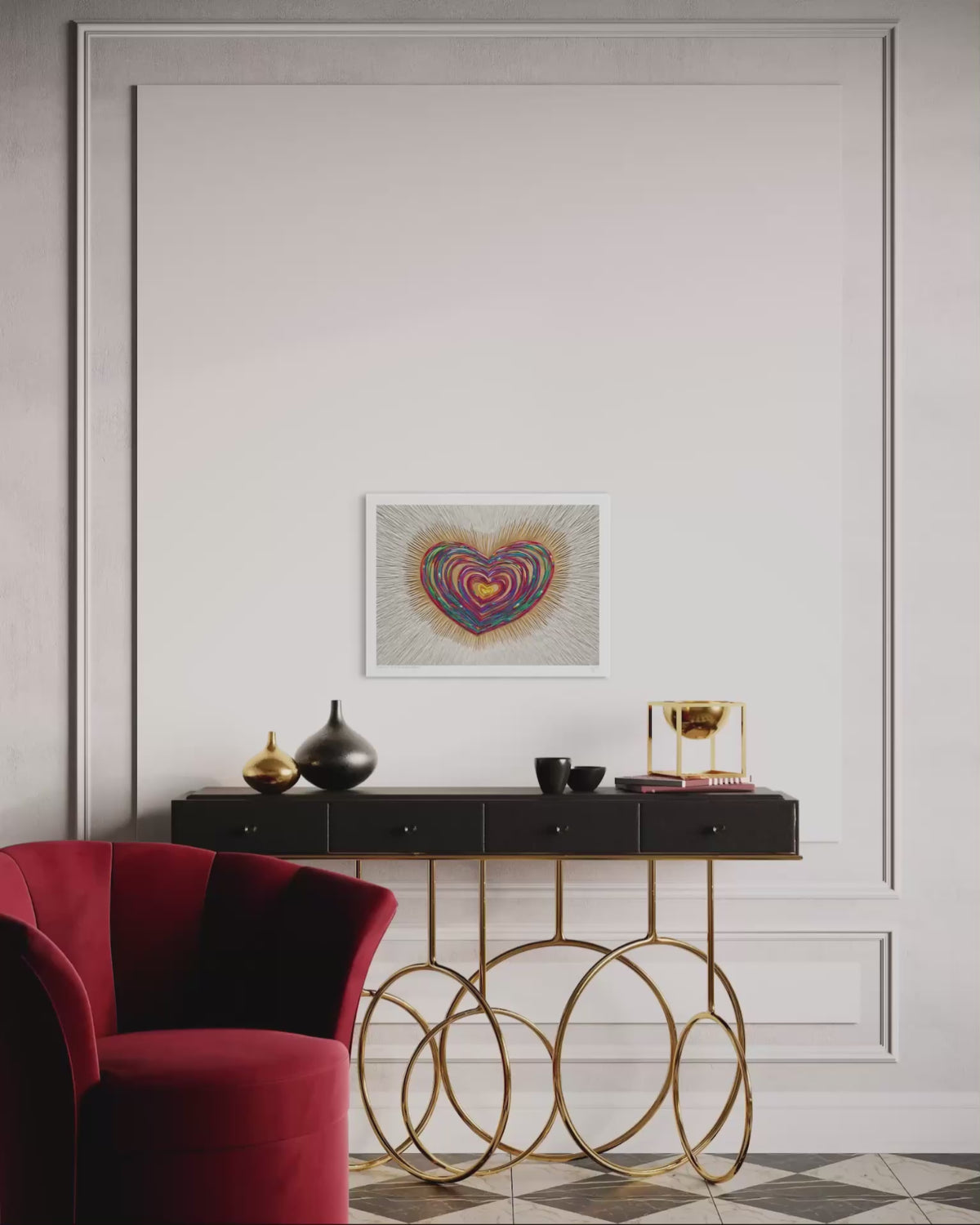 video of the A3 art print featuring a colorful, swirling heart piece called ''Only Love'' hanging on a white paneled wall above a black console table with gold metal legs. A red velvet armchair is visible in the foreground on a checkered floor.