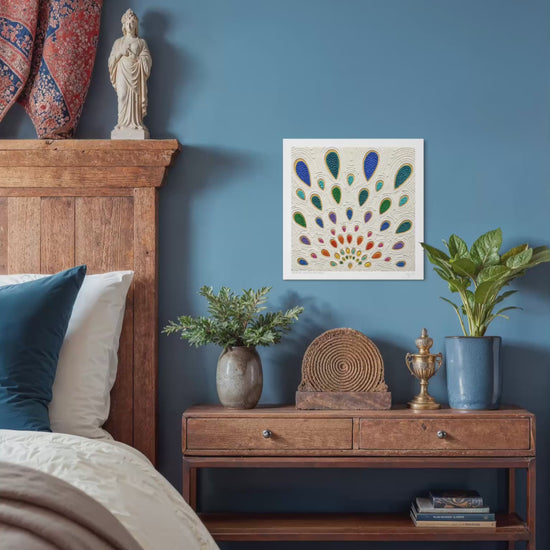 A video close up of An abstract art print called ''Growth'' by clay artist Emy Oikawa. A colorful peacock feather-like shapes expanding outwards. The print hangs on a blue wall in a styled bedroom. The scene includes a wooden bed frame, nightstand, plants, woven baskets, and decorative objects.